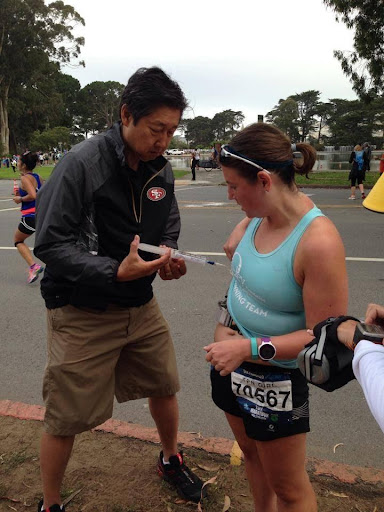 NUTRISHARE CLINICAL COORDINATOR REID NISHIKAWA, PHARMD, BCNSP, FASPEN, HELPS OUR PATIENT WITH HER PUMP, DELIVERING VITAL NUTRIENTS DURING A RACE.